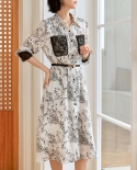 Vestido de encaje de costura de temperamento Otoño Nuevo estilo Falda de gasa floral con cinturón de longitud media