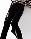 بنطال جينز أسود رفيع قابل للتمدد بتصميم نسائي سحاب مجوف بخصر عالٍ وأقدام صغيرة على الورك