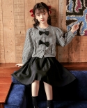 Traje de falda para niños de otoño Traje de niñas con top a cuadros de estilo occidental con lazo negro